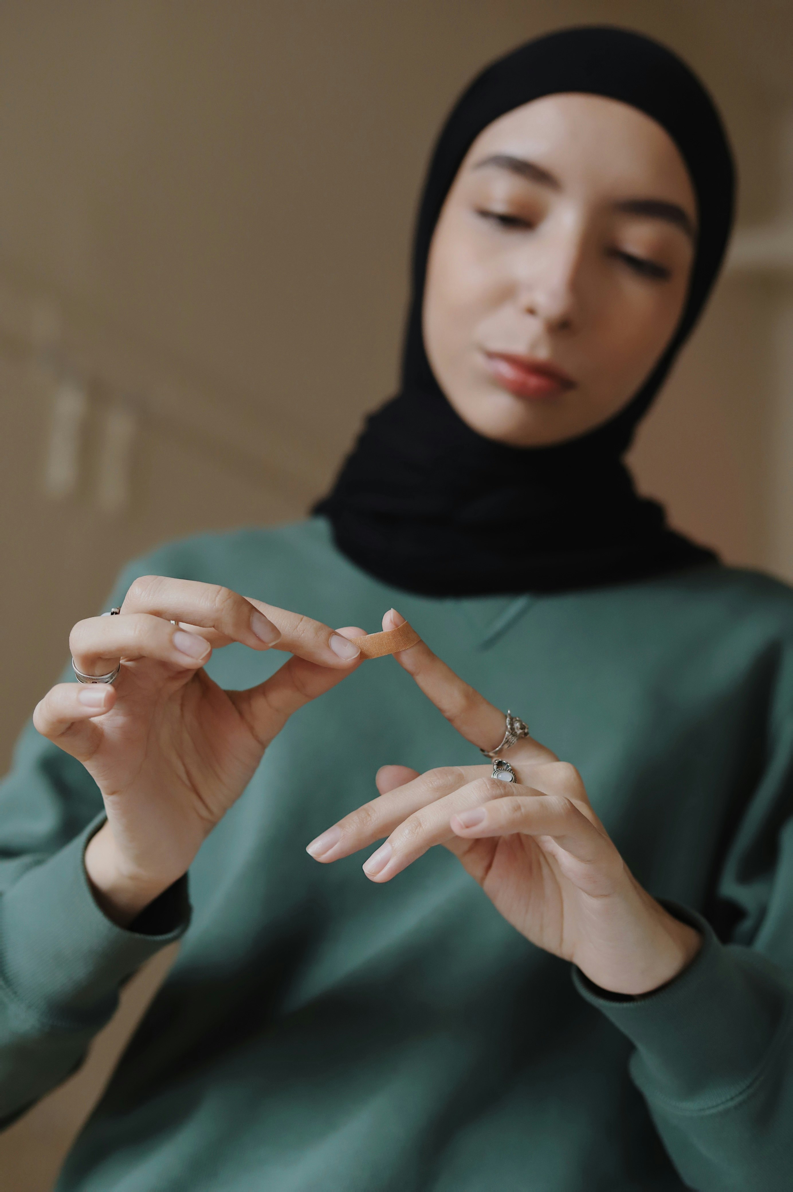 woman in green hijab and black hijab